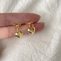 Detail of gold bow earrings with heart pendant featuring EAR PARTNER engraving - Gold Bow Heart Stud Earrings