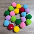Detail of colorful fuzzy felt ball garland with vibrant pom poms on a rustic wood surface - Multi-color 2m Pompom String (20 Balls)