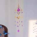 Golden geometric suncatcher with purple crystal prism reflecting rainbows on wall - Purple