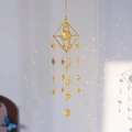 Golden geometric suncatcher with yellow crystal ball creating colorful rainbow light - Yellow