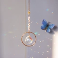 Detailed close-up of crystal suncatcher with pink stones and clear prism reflecting light - Rose Quartz