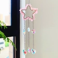 Pink star-shaped crystal suncatcher with hanging heart and teardrop prisms - Star