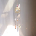 Detail of sun and moon crystal suncatcher reflecting rainbow light spots on a wall - Hollow Sun and Moon Style (A25)