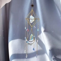 Close-up of geometric sun catcher with purple amethyst and crystal prism on blue silk - Opalite