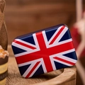 Detail of rectangular Union Jack tin box with British flag lid on a rustic wooden tray - UK Flag Style