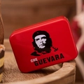 Detail of red rectangular tin box featuring Che Guevara portrait on a wooden surface - Red Portrait Design