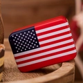 Macro view of rectangular tin candy box with vibrant American flag design on wooden base - US Flag Style