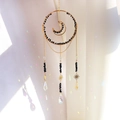 Golden moon sun catcher with black crystal gravel and rainbow prism reflections - RD4-Obsidian