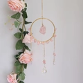 Bohemian suncatcher with pink crystals and golden metal ring hanging by pink roses - Rose Quartz (RC1)