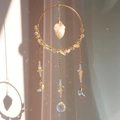Macro view of crystal suncatcher showing gold ring and rainbow prism light effect - Citrine (RC7)