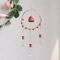 Detail of crystal suncatcher with gold ring, red raw stones and iridescent prisms - Red Jasper (RC10)