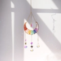 Macro shot of moon shaped crystal suncatcher with chakra stones casting rainbow shadows - 7 Chakra Crystal Moon Ornament (MC-2)