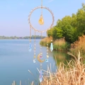 Golden suncatcher with crystal ring and butterfly charms over a bright lake backdrop - 55cm / Citrine