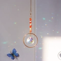 Golden suncatcher with orange natural crystals and a crystal ball making rainbow prisms - Red Agate