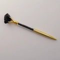 Detail of golden ballpoint pen featuring clear barrel filled with black crystal gravel - Black Tourmaline