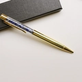 Detail of a golden pen filled with blue crystal gravel on a black gift box base - Lapis Lazuli / 14.5cm