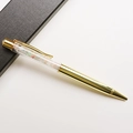 Close-up of golden metal ballpoint pen filled with colorful crystal crushed stones - Morganite / 14.5cm