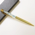 Detail of a gold crystal pen with blue crushed stones inside a black textured gift box - Aquamarine / 14.5cm