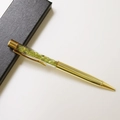 Detail view of golden crystal ballpoint pen with green gemstone filling and black gift box - Peridot / 14.5cm
