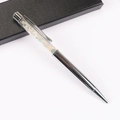 Detail of silver metal ballpoint pen with colorful natural crystal stones in clear tube - Morganite