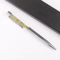Detail of silver metal pen with green crystal gravel stones and a black gift box - Peridot
