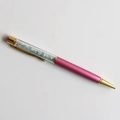 Close-up of rose pink crystal ballpoint pen with light blue stones and gold metal accents - Aquamarine / 14cm Black Ink Refill