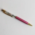 Detail of a rose red crystal ballpoint pen with gold accents and internal purple gravel - Morganite / 14cm Black Ink Refill