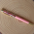 Detail view of pink crystal ballpoint pen with natural red crushed stones and gold accents - Red Agate