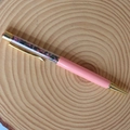 Detail of pink crystal ballpoint pen with gold metal accents and floating gemstone chips - Mixed Tourmaline