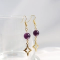 S925 silver star amethyst earrings in gold finish hanging on a glass rim - Amethyst Star Earrings