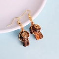 Macro shot of handmade wire-wrapped mushroom earrings with natural stone and golden wire - Tiger Eye Stone Bracelet