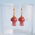 Detail of handmade mushroom earrings with red quartz stones and gold wire wrap craft - Strawberry Quartz