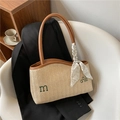 Large beige woven straw tote bag with brown leather handles and green letter embroidery - Brown