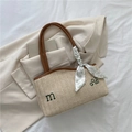 Large beige woven straw tote bag with brown leather straps and floral scarf accessory - Brown
