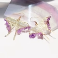 Bohemian gold wire butterfly earrings with purple amethyst chips on a stone background - Amethyst Butterfly Style