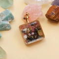 Detailed view of square gold perfume pendant filled with colorful natural crystal stones - Mixed Tourmaline / 29mm