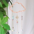 Pink crystal suncatcher with golden clouds, evil eye charms, and prismatic glass sphere - CA1-Rose Quartz