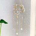 Macro detail of suncatcher showing crystal prisms casting rainbow light on the wall - Rose Quartz Style(CC4)
