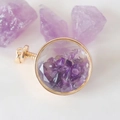 Detail view of round gold perfume bottle pendant filled with purple amethyst crystals - Amethyst / 29mm