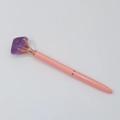 Dettaglio della penna a sfera in cristallo rosa con pietra grezza viola in oro rosa - Ametista