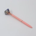 Detail of pink crystal ballpoint pen with rose gold claw and natural blue gemstone top - Lapis Lazuli