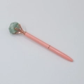 Detail of pink ballpoint pen with rose gold metal finish and green raw crystal top - Aventurine Jade