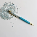 Detail of creative ballpoint pen with sky blue body and blue crystals in the barrel - Aquamarine