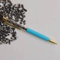 Detail of light blue ballpoint pen with metallic grey crystals in clear barrel and gold trim - Terahertz
