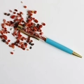 Creative crystal ballpoint pen with reddish gravel filling and blue metallic finish - Red Agate