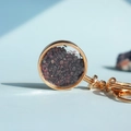 Round golden crystal keychain pendant filled with deep red garnet mineral stones - Garnet