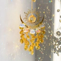 Golden sun and moon crystal suncatcher with rainbow reflections on a white wall - 32cm / Yellow