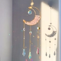 Detailed suncatcher view with pink crystal moon and rainbow prism reflections - Rose Quartz