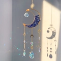 Detail of crystal suncatcher with golden moon frame and blue stones casting light prisms - Lapis Lazuli