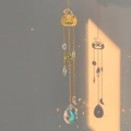 Golden Halloween pumpkin suncatcher with crystal beads casting rainbow light on wall - Pumpkin
